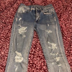 light blue ripped American eagle skinny jeans